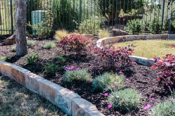 landscaped flower bed and stone border- lawncare coppell texas